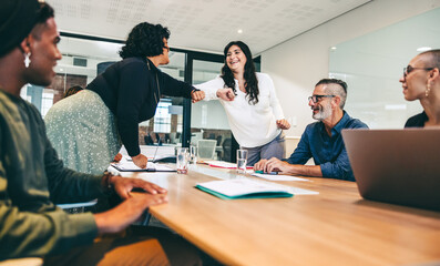 Female colleagues elbow bumping each other before a meeting