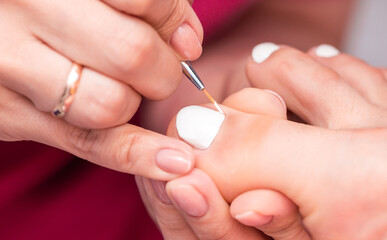 Pedicure care for your feet makes a professional master in the salon Spa procedures, relaxation at a cosmetologist.