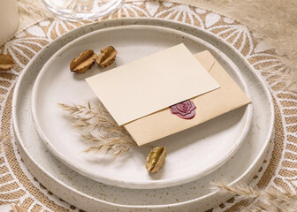 Boho Wedding Table place with Blank card over envelope near pampas grass