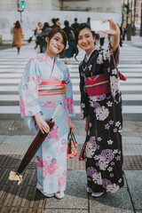 Storytelling image of two japanese girls wearing kimono spending time in Tokyo. Traditional clothes lifestyle moments from the local culture in Japan