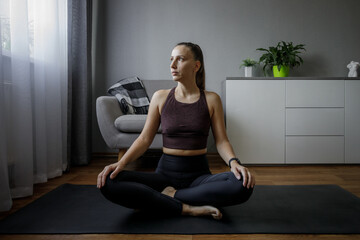 Young woman doing yoga meditation routine in the morning.
