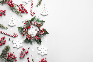 Beautiful Christmas composition with balls, wreath and candy canes on white background