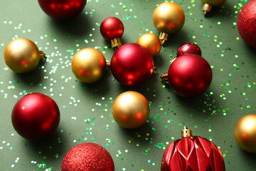 Stylish Christmas balls on green background