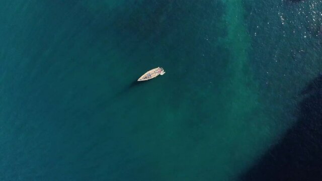 The sailing yacht is in the bay. Aerial view. Sunny day. Cinematic serene, calm and relaxing concept