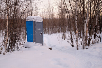 outdoor chemical toilet in the winter park . Eco-friendly bio toilet in nature. Blue Cabine Of Bio...