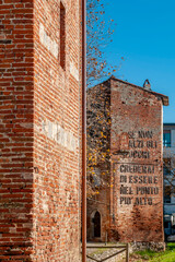 The towers of the city walls of Cascina, Pisa, Italy, with the exhortation to look higher