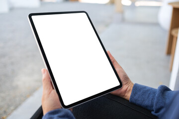 Mockup image of a woman holding digital tablet with blank white desktop screen in the outdoors