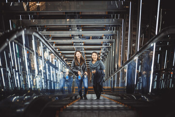 Two japanese women around in Tokyo during daytime. Making shopping and having fun