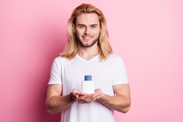 Photo of positive happy man hold hands shave lotion good mood smile isolated on pink color background