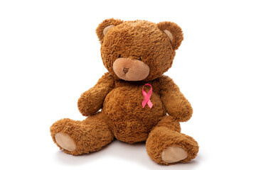 medicine, healthcare and oncology concept - teddy bear toy with pink breast cancer awareness ribbon on white background