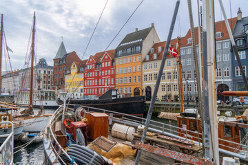 Fototapeta na wymiar Copenhagen, Denmark - October 1, 2021: view of Nyhavn pier with colorful buildings and boats in Old Town of Copenhagen