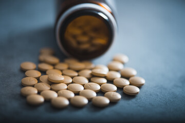 Different type of pills on a a dark background with the copy space. Group of capsules. Concept of medicine.