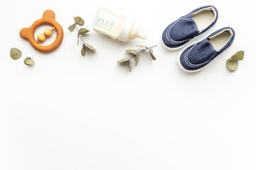 Baby newborn accessories with blue booties bootle of milk and toy