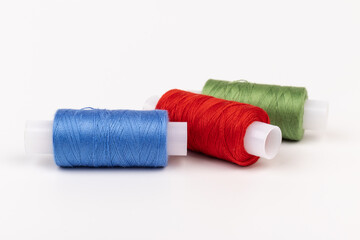 Color sewing threads isolated on white background. Different colors.Bright bobbin thread.