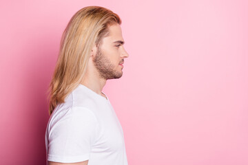 Profile side photo of charming attractive young man look empty space isolated on pastel pink color background