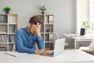 Stressful office job finally turns young man into a burnout. Stressed, tired, exhausted male worker...
