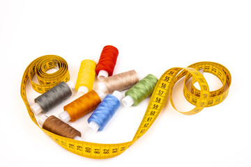 Sewing threads, sewing centimeter or measuring tape, isolated on white background.