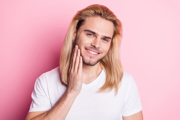 Photo of adorable sweet young gentleman dressed white t-shirt smiling arm cheek isolated pink color background