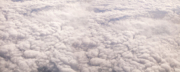 Plane window view with clouds.