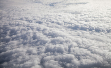 Plane window view with clouds.