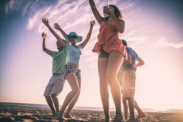 Group of friends having fun on the beach in Los angeles. Storytelling image of multiethnic people...