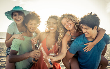 Group of friends having fun on the beach in Los angeles. Storytelling image of multiethnic people...