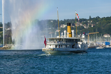 famous water jet and a vintage steamboat cruising on Lake Geneva, Geneva, Switzerland