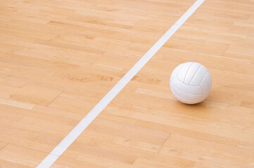 Volleyball ball and white line on wooden court. Horizontal education and sport poster, greeting cards, headers, website