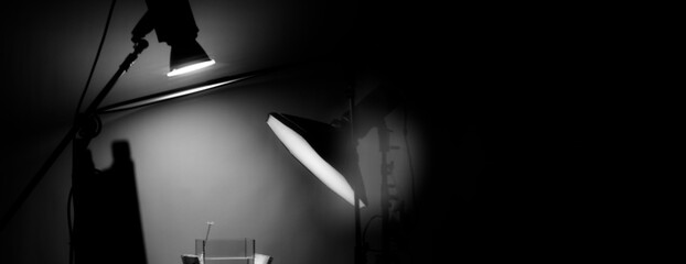 Blurry images of Studio light equipment for filming movie video or professional photo shooting. Shot on monitor screen reflects. Lights studio on tripod for video recording. Soft focus blur images.