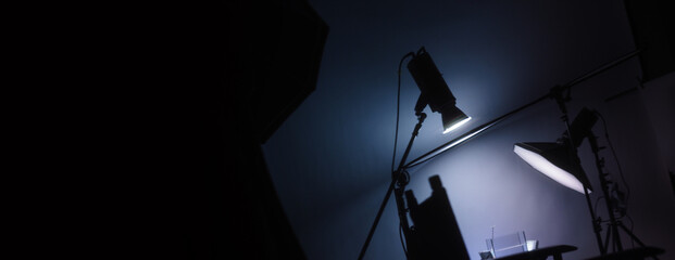 Blurry images of Studio light equipment for filming movie video or professional photo shooting. Shot on monitor screen reflects. Lights studio on tripod for video recording. Soft focus blur images.
