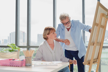 Senior couple do art painting together with happy and romantic emotion.