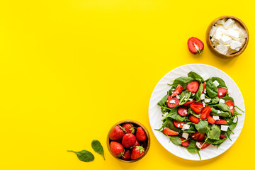 Vegetarian diet - green spinach salad with strawberry and goat cheese