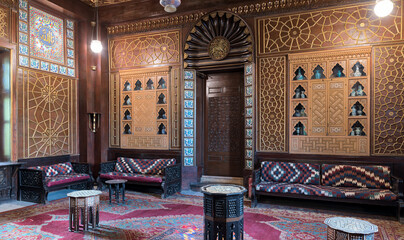 Manial Palace of Prince Mohammed Ali. Guests Hall with wooden ornate ceiling, wooden ornate door,...