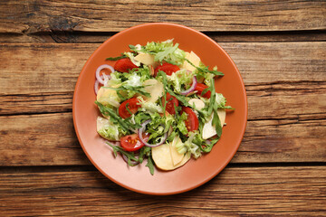 Delicious turnip salad served on wooden table, top view