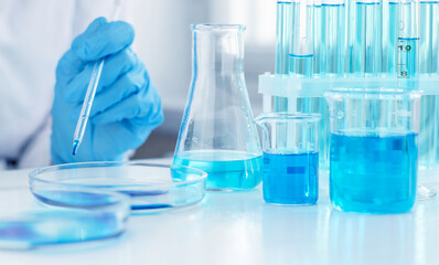 A laboratory pipette is in the hands of a scientist. A scientist is conducting research on a vaccine against coronavirus. Laboratory clinical trials.