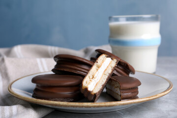Tasty choco pies and milk on grey table © New Africa
