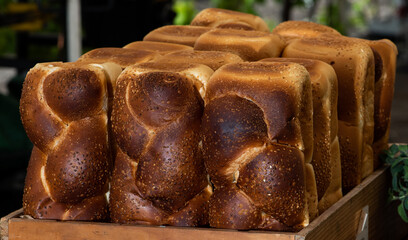 Few challah breads  in a box arranged vertically