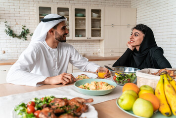 happy family spending time together at home during the Dubai national day. Arabian parents and...