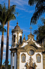 Fototapeta na wymiar Baroque church and palm trees in Sao Joao del Rei, Brazil
