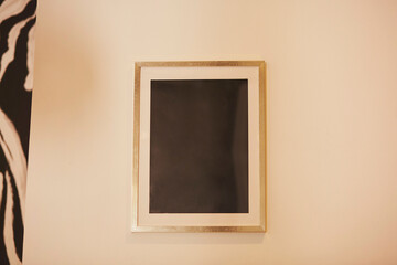 Wall picture frame black mock up for design or text. Evening light