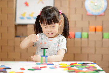 young girl play number sticks fine motor skill game for homeschooling