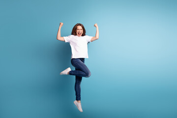 Full body photo of young pretty girl good mood rejoice victory triumph fists hands isolated over...