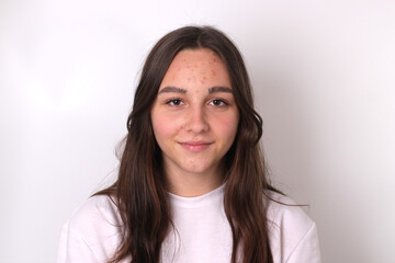 Portrait of authentic cute teenage girl without makeup on light background.