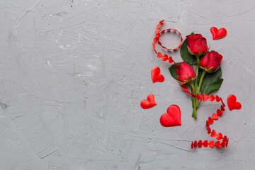 Valentine day composition with rose flower and red heart on table. Top view, flat lay, copy space Holiday concept