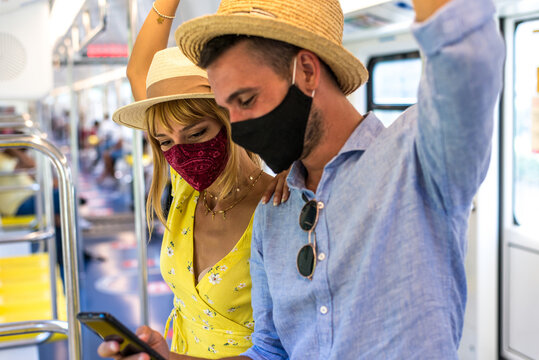 Image of a happy couple traveling in the metro commuter during 2020 pandemic events