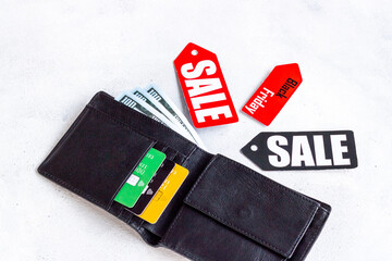 Sale tag and wallet with banknotes and bank cards