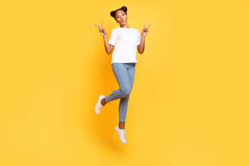 Fototapeta na wymiar Full length photo of young pretty girl jumper show fingers peace cool v-symbol isolated over yellow color background
