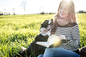 Beautiful woman with her loyal border collie dog at the park