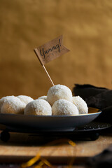 Preparing candies in coconut flakes and fresh coconut, homemade dessert cooking