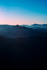 View from the mountains to the hills after sunset. Clear sky.